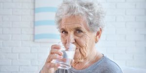 Elderly woman drinking water